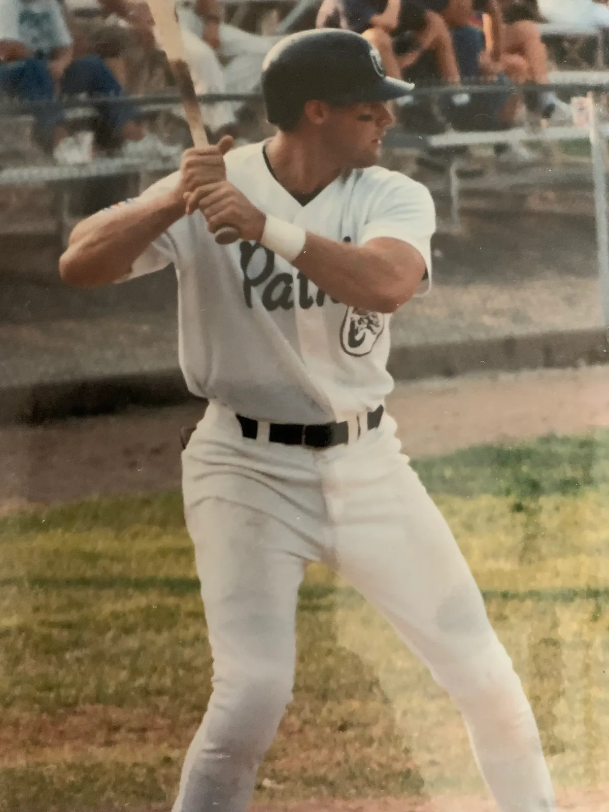 Steve Grandizio playing baseball in uniform on a baseball field with the stands behind him
